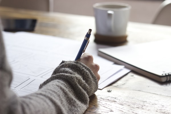 Person studying for tech certifications with notes and laptop