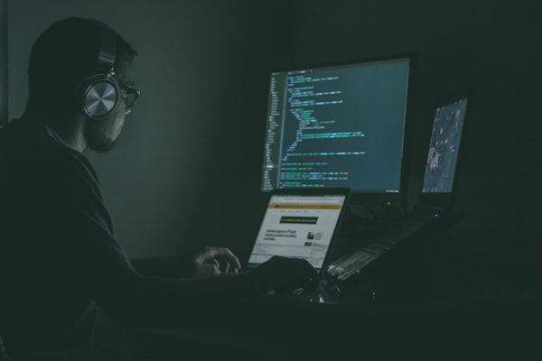 Code scrolling on a monitor representing chat flooding scripts